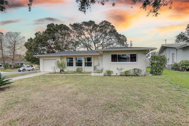 ranch-style house with a lawn and a garage