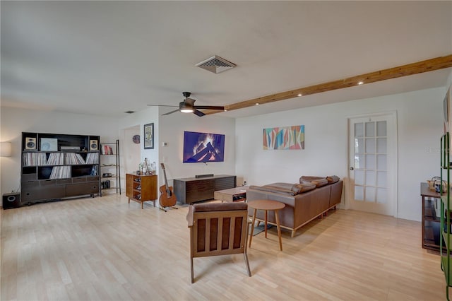 living room with light hardwood / wood-style floors, beam ceiling, and ceiling fan