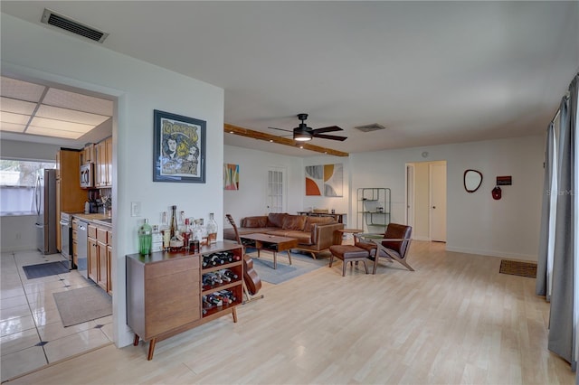 living room featuring light hardwood / wood-style floors and ceiling fan