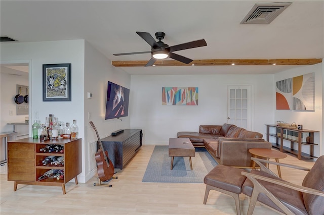 living room with ceiling fan, beam ceiling, and light hardwood / wood-style floors