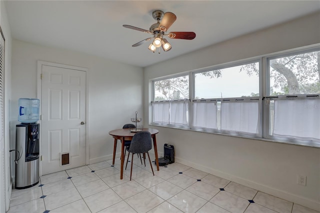 tiled dining space with ceiling fan