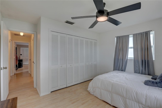 bedroom featuring light hardwood / wood-style flooring, a closet, and ceiling fan