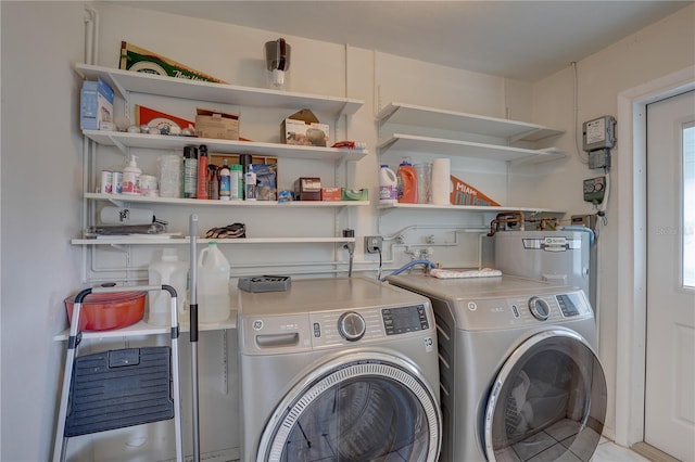 laundry area featuring water heater and washing machine and dryer