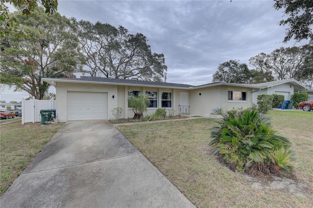 ranch-style home with a garage and a front yard