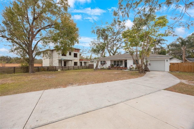 view of front of home featuring a garage and a front yard