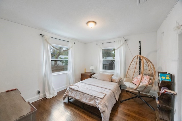 bedroom with dark hardwood / wood-style flooring