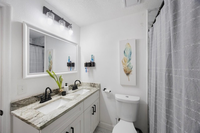 bathroom featuring a textured ceiling, toilet, vanity, and a shower with shower curtain