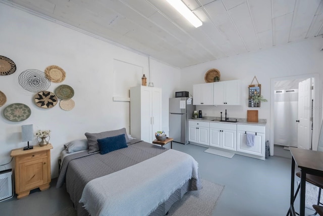 bedroom featuring stainless steel fridge and sink