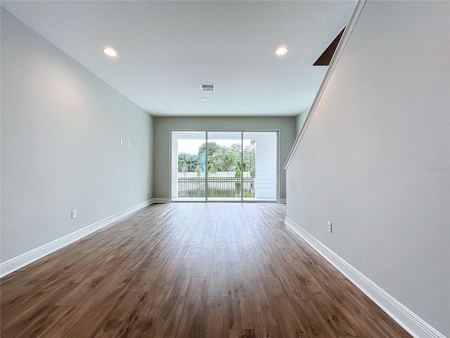 interior space with hardwood / wood-style floors and a textured ceiling