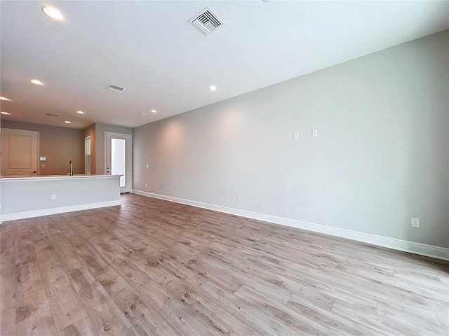 unfurnished living room with light hardwood / wood-style floors