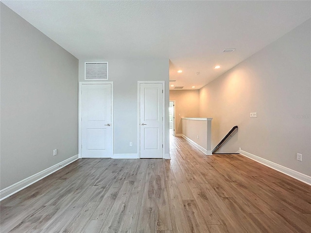 empty room with light hardwood / wood-style floors