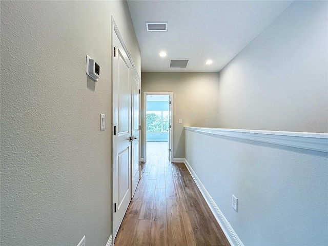 corridor featuring wood-type flooring