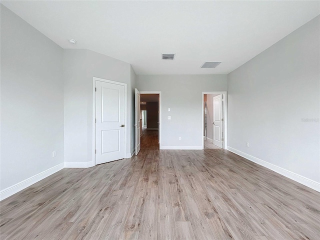 spare room featuring light hardwood / wood-style floors