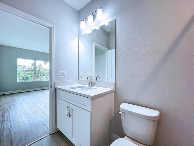 bathroom with toilet and vanity