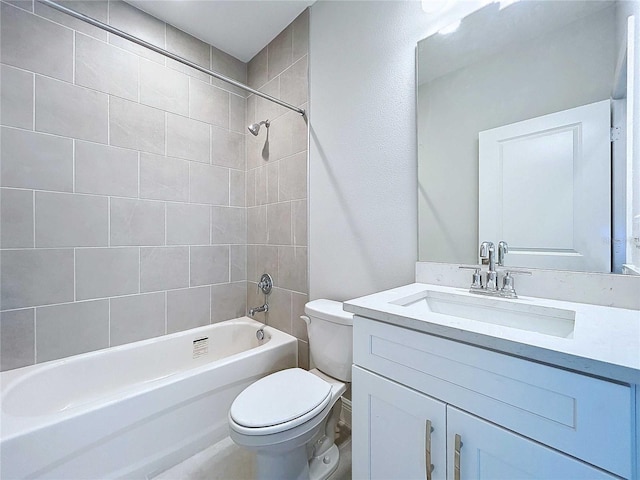 full bathroom featuring toilet, tiled shower / bath combo, and vanity