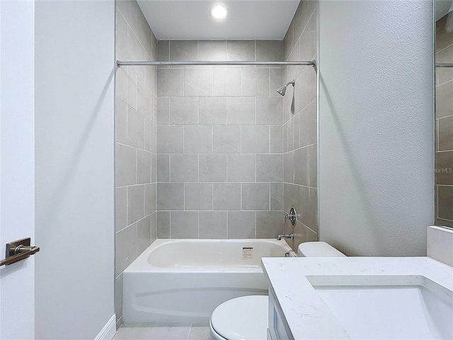 full bathroom featuring toilet, tiled shower / bath combo, tile patterned floors, and vanity