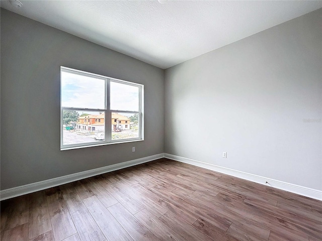 spare room with hardwood / wood-style floors