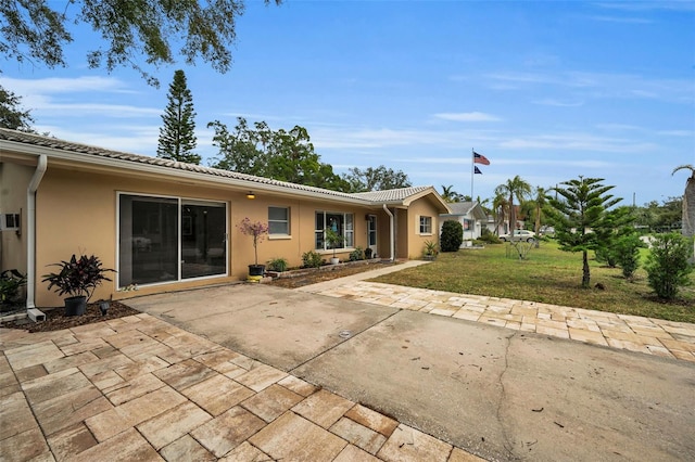 view of front facade with a front lawn and a patio