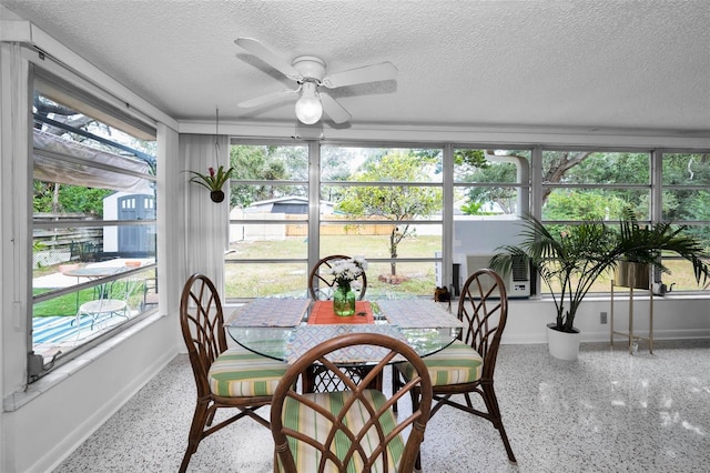 sunroom / solarium featuring ceiling fan