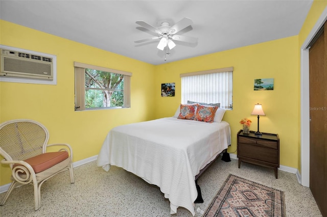 bedroom featuring ceiling fan, a wall mounted AC, and a closet