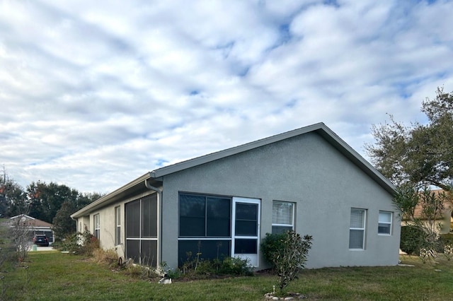 view of side of property with a yard