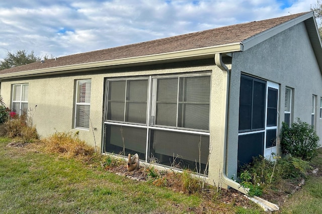 view of home's exterior with a lawn