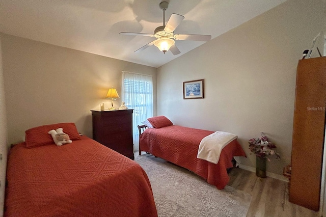 bedroom with lofted ceiling, hardwood / wood-style floors, and ceiling fan