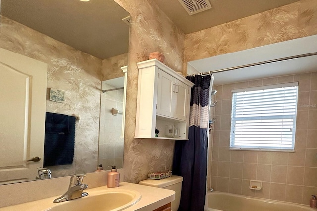 full bathroom with shower / bath combo, vanity, and toilet