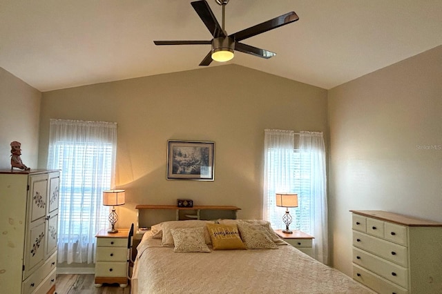 bedroom with multiple windows, lofted ceiling, light wood-type flooring, and ceiling fan