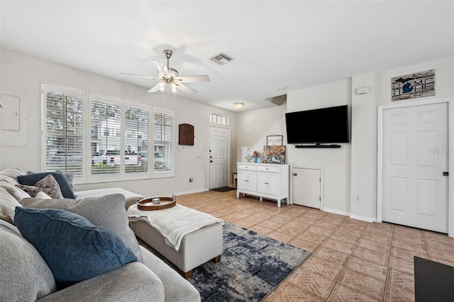 living room with ceiling fan and light tile patterned floors