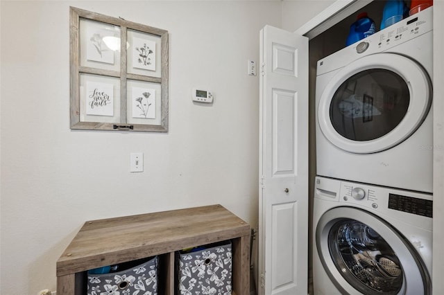 washroom featuring stacked washer and clothes dryer