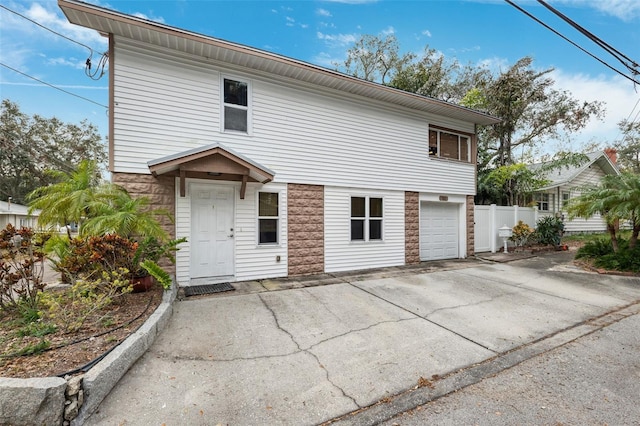 view of front of house with fence and a garage
