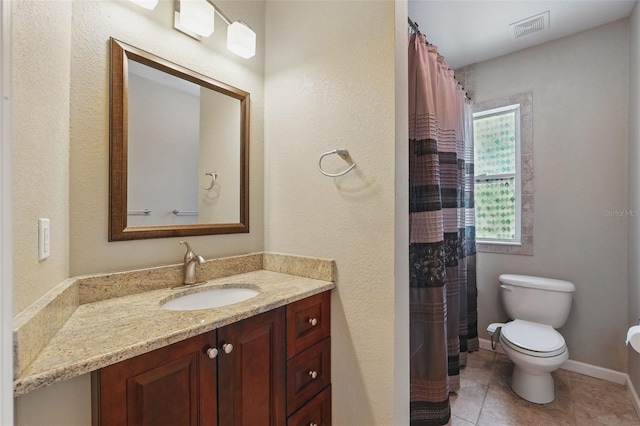 full bathroom featuring toilet, vanity, tile patterned flooring, baseboards, and visible vents