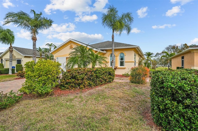 view of front facade with a garage and a front yard