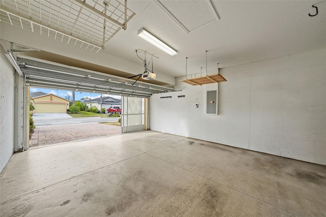 garage featuring a garage door opener and electric panel