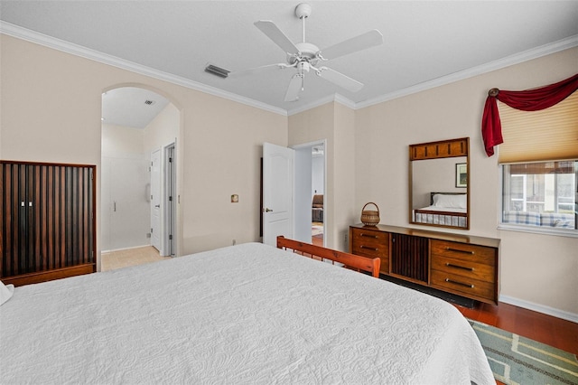 bedroom with ceiling fan, ornamental molding, dark hardwood / wood-style flooring, and ensuite bath