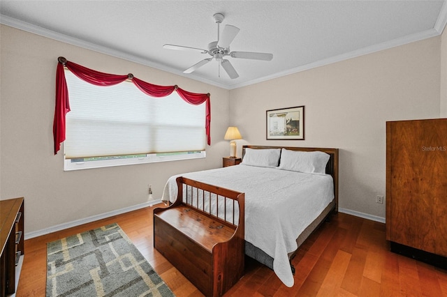 bedroom featuring ceiling fan, wood-type flooring, and ornamental molding