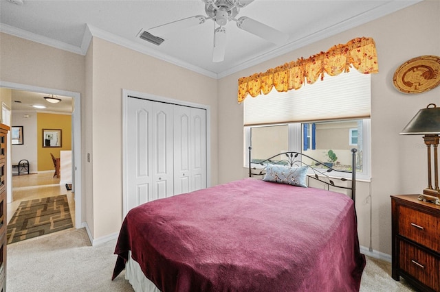 bedroom with ceiling fan, ornamental molding, a closet, and multiple windows