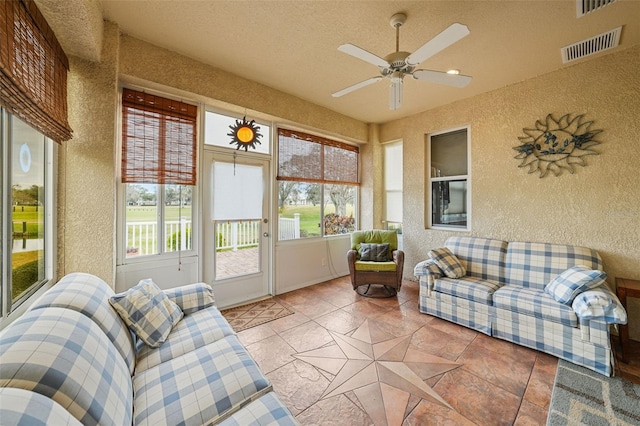 sunroom / solarium featuring ceiling fan