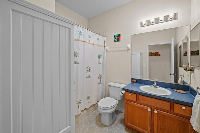 bathroom featuring toilet, vanity, tile patterned flooring, and a shower with shower curtain