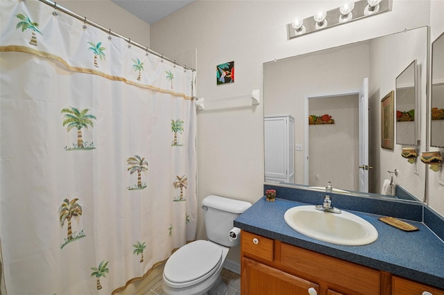 bathroom featuring toilet and vanity