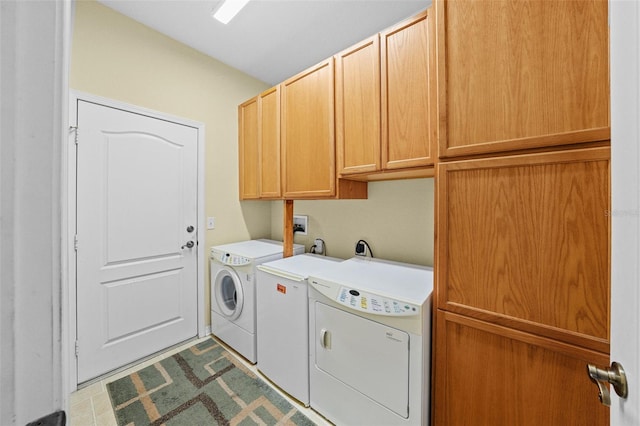 laundry area with washer and dryer and cabinets