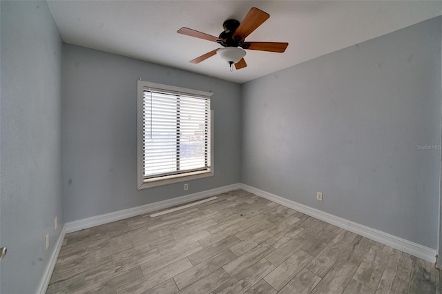 empty room with ceiling fan and light wood-type flooring