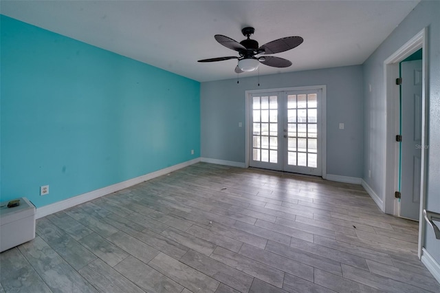 spare room featuring ceiling fan and french doors