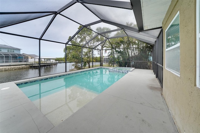 view of pool with glass enclosure, a water view, and a patio