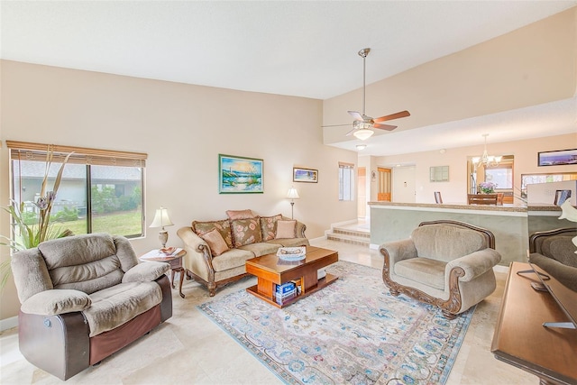 tiled living room with vaulted ceiling and ceiling fan with notable chandelier