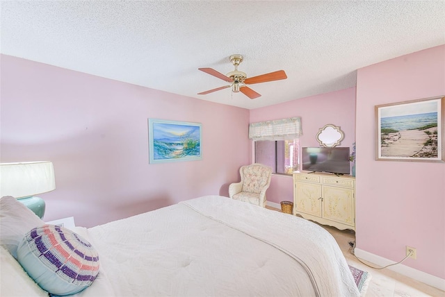 bedroom with a textured ceiling and ceiling fan