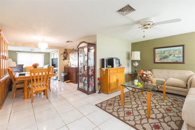 living room with ceiling fan and light tile patterned flooring