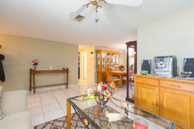 living room featuring ceiling fan and light tile patterned floors