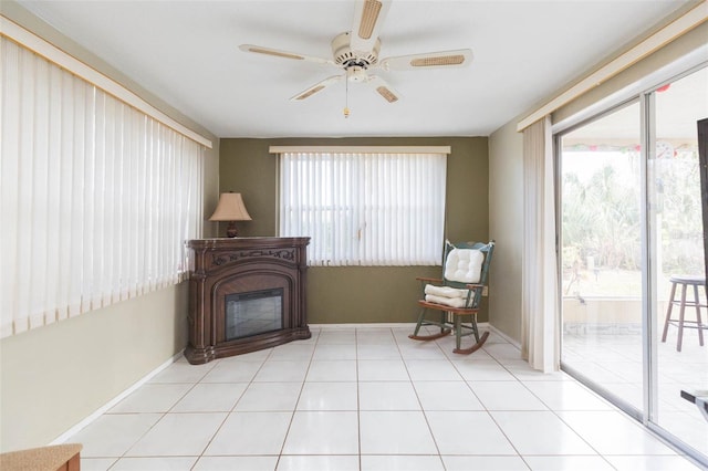 sitting room featuring ceiling fan and light tile patterned flooring